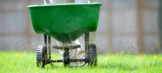 lawn technician seeding a lawn